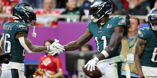 A.J. Brown #11 of the Philadelphia Eagles celebrates with Miles Sanders #26 of the Philadelphia Eagles after catching a 45-yard touchdown pass during the second quarter against the Kansas City Chiefs in Super Bowl LVII at State Farm Stadium on February 12, 2023, in Glendale, Arizona.