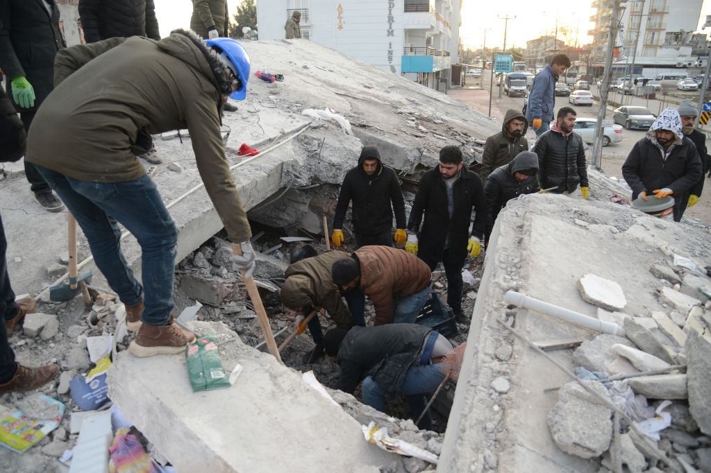 Residents and rescue personnel search for victims and survivors through the rubble of collapsed buildings in Adiyaman, Turkey on Feb. 8, 2023.