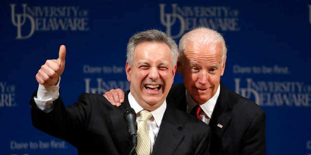 FILE - In this March 13, 2017, file photo, former Vice President Joe Biden, right, embraces University of Delaware President Dennis Assanis during an event to formally launch the Biden Institute, a research and policy center focused on domestic issues at the University of Delaware, in Newark, Del. 