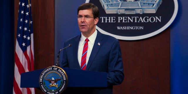 In this image provided by the Department of Defense, Defense Secretary Mark Esper speaks to members of the media during a news conference to discuss the department's efforts in response to the COVID-19 pandemic at the Pentagon Briefing Room in Washington, on Monday, March 23, 2020. (Army Staff Sgt. Nicole Mejia/Department of Defense via AP)