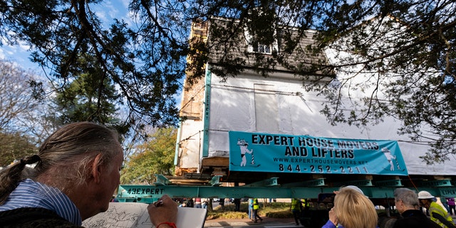 Mel Horan, of Williamsburg, sketches The Bray School as it is moved down Prince George Street in Williamsburg, Va. on Friday, Feb. 10, 2023. The building is being moved off of the campus of William &amp; Mary and into Colonial Williamsburg. It is believed to be the oldest surviving schoolhouse for Black children in the U.S., built 25 years before the American Revolution. 