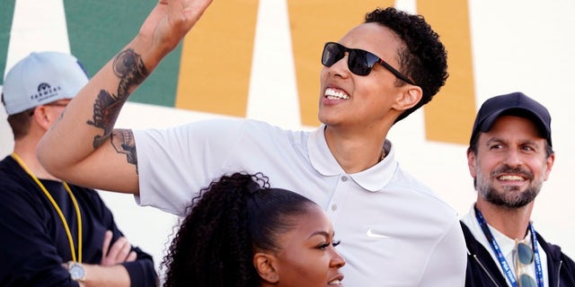 American professional basketball player Brittney Griner acknowledges fans as she watches on the 16th hole during the third round of the Phoenix Open golf tournament, Saturday, Feb. 11, 2023, in Scottsdale, Arizona.