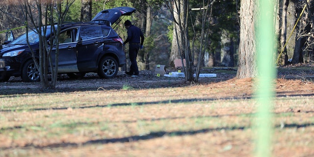 Law enforcement personnel investigate the scene of multiple shootings on Arkabutla Dam Road in Arkabutla, Mississippi, on Friday, Feb. 17, 2023. 