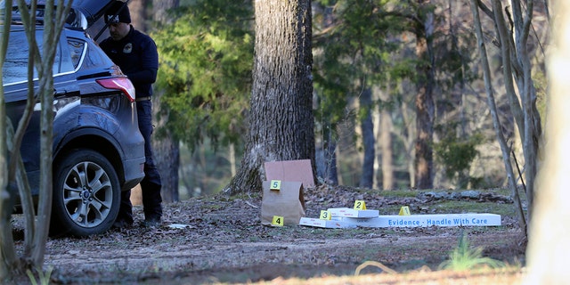 Law enforcement personnel investigate the scene of multiple shootings on Arkabutla Dam Road in Arkabutla, Mississippi, on Friday, Feb. 17, 2023. 