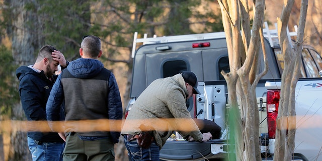 Law enforcement personnel investigate the scene of multiple shootings on Arkabutla Dam Road in Arkabutla, Mississippi, on Friday, Feb. 17, 2023. 