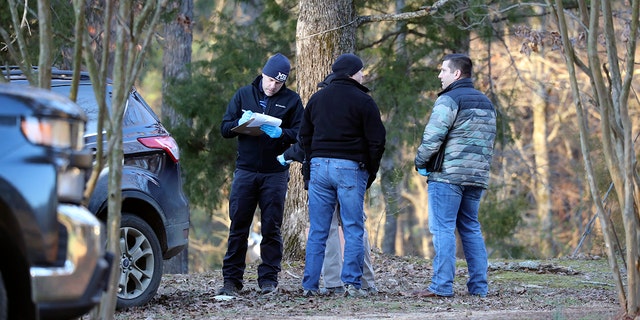 Law enforcement personnel investigate the scene of multiple shootings on Arkabutla Dam Road in Arkabutla, Mississippi, on Friday, Feb. 17, 2023. 