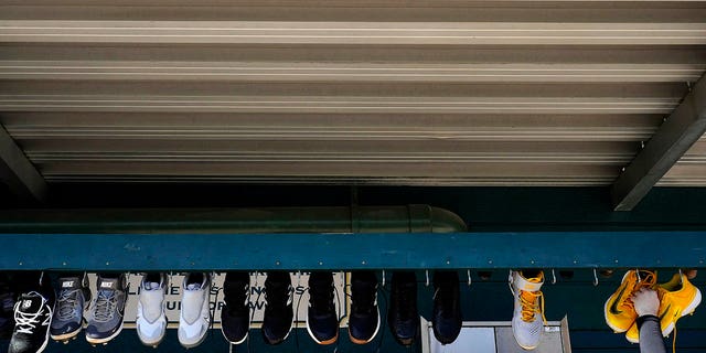 An attendant takes Pittsburgh Pirates shoes down to clean during spring training on Saturday, Feb. 18, 2023, in Bradenton, Florida.