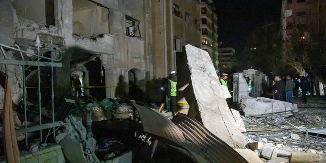 In this photo released by the Syrian official news agency SANA, people view the damage in residential neighborhood after an early morning Israeli airstrike in Damascus, Syria, Sunday, Feb. 19, 2023. (AP)