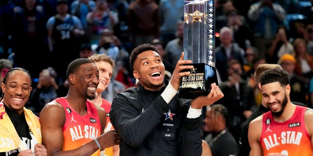 Giannis Antetokounmpo holds up the winning team trophy after the NBA All-Star Game Sunday, Feb. 19, 2023, in Salt Lake City. 