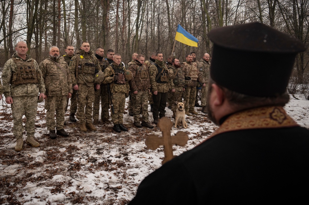 A priest blessing Ukrainian soldiers in the Kharkiv are on February 25, 2023.