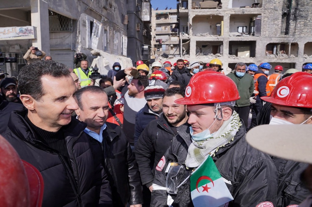 President Bashar al-Assad meets with Algerian rescue team at the site of a damaged building, in the aftermath of the earthquake in Aleppo, in this handout released by Syrian Presidency on February 10, 2023.