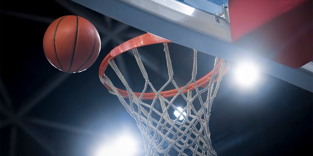 Closeup of a basketball reaching a hoop