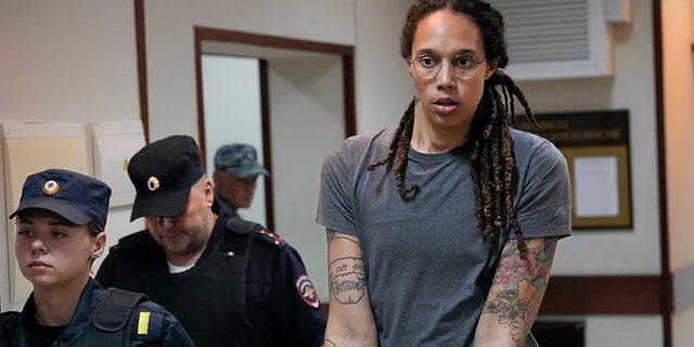 WNBA star and two-time Olympic gold medalist Brittney Griner is escorted from a courtroom after a hearing in Khimki, Russia, Thursday, Aug. 4, 2022.