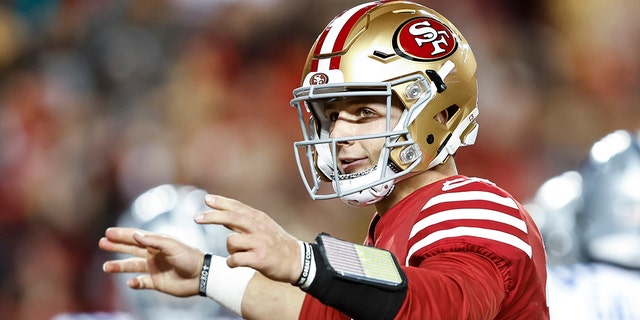 Brock Purdy of the San Francisco 49ers celebrates after handing off the ball for a touchdown during an NFL divisional round playoff game against the Dallas Cowboys at Levi's Stadium Jan. 22, 2023, in Santa Clara, Calif.