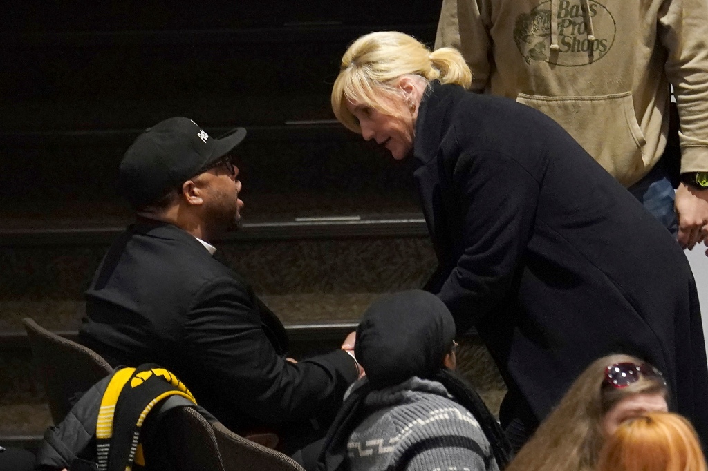 Activist Erin Brockovich talks to a resident of East Palestine before speaking at a town hall meeting at East Palestine High School, Friday, Feb. 24, 2023.