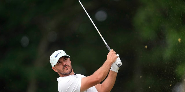 Brooks Koepka watches his shot on the 11th hole during the second round of the U.S. Open golf tournament at The Country Club, Friday, June 17, 2022, in Brookline, Mass.