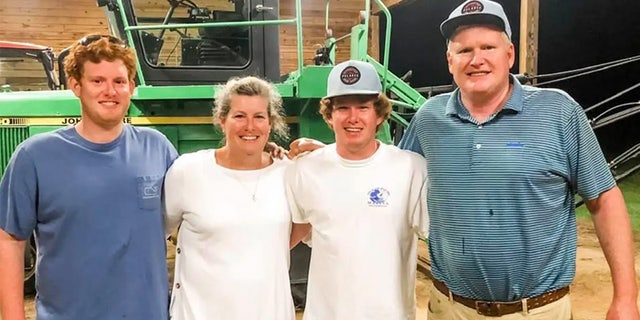 Buster Murdaugh, left, stands with his mother, Maggie; his brother, Paul; and his father, Alex.