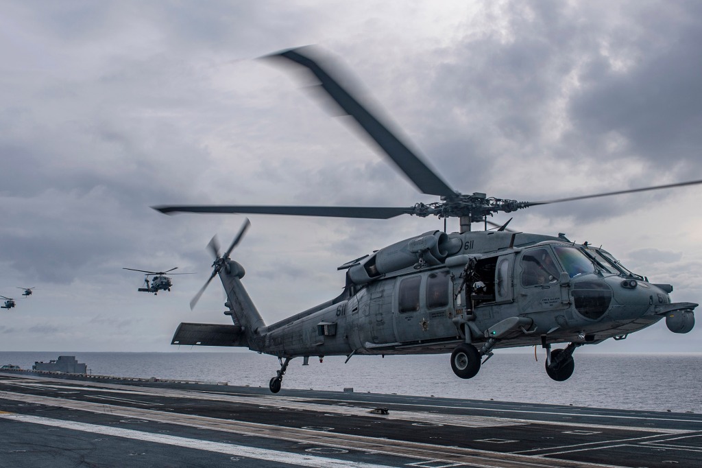 An MH-60S Sea Hawk helicopter lands aboard the aircraft carrier USS Nimitz in the South China Sea, Sunday, Feb. 12, 2023