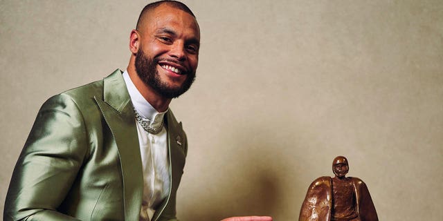 Dak Prescott poses for a photo after winning the Walter Payton Man of the Year award during NFL Honors at the Symphony Hall on February 9, 2023, in Phoenix, Arizona. 