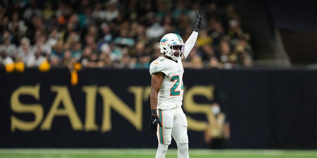 Byron Jones of the Miami Dolphins raises an arm during a game against the New Orleans Saints at Caesars Superdome Dec. 27, 2021, in New Orleans. 