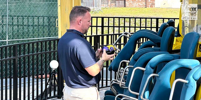 Representatives Austrian ride manufacturer, Funtime Handels inspect the Freefall drop tower ride at Icon Park in Orlando Florida, Thursday, February, 23, 2023. Ride goer, Tyree Sampson died when he fell from the ride in March last year. A man uses a camera to document the inspection. 