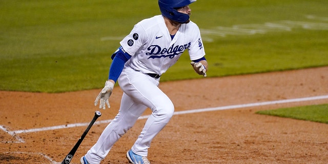 Los Angeles Dodgers' Gavin Lux drops his bat as he hits a grand slam during the seventh inning of a baseball game against the Arizona Diamondbacks Tuesday, May 18, 2021, in Los Angeles. (AP Photo/Mark J. Terrill)