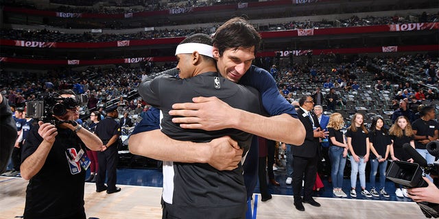 Boban Marjanović of the Dallas Mavericks and Tobias Harris of the Philadelphia 76ers hug before a game Jan. 11, 2020, at the American Airlines Center in Dallas, Texas. 