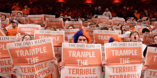 The Orange Krush student section read The Daily Illini newspaper while the visiting team is introduced before the start of the Big Ten Conference college basketball game between the Maryland Terrapins and the Illinois Fighting Illini on Feb. 7, 2020, at the State Farm Center in Champaign, Illinois. 