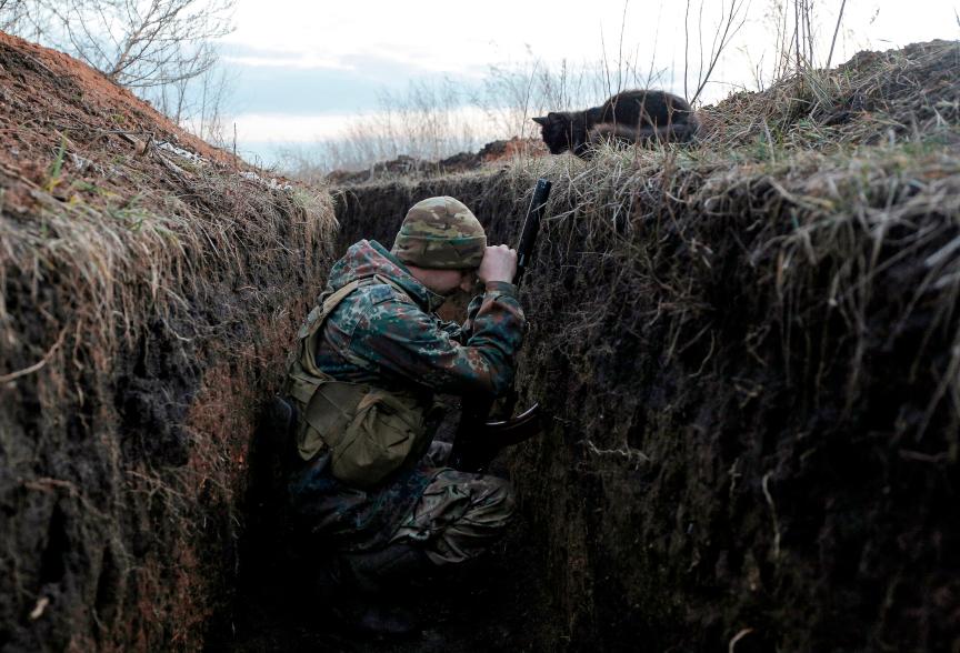 A Ukrainian soldier resting in a trench.