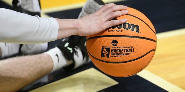 A championship logo is seen on a basketball as a player warms up for the Division III National Championship basketball game between the Randolph-Macon Yellow Jackets and the Elmhurst Bluejays on March 19, 2022, at the Allen County War Memorial Coliseum in Fort Wayne, Indiana. 