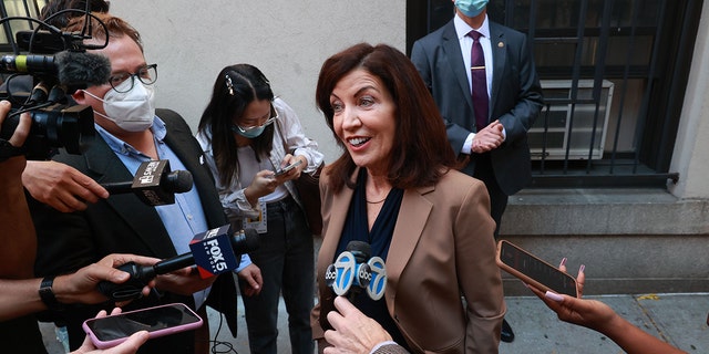 New York Governor Kathy Hochul, center, talks to reporters after visiting the Hamilton Housing Development on West 73rd Street and Broadway in the Upper West side of Manhattan, New York. 