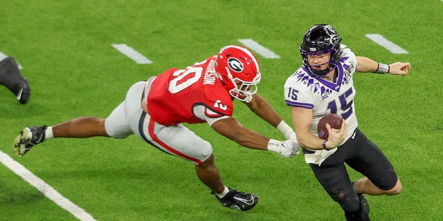 Georgia Bulldogs linebacker Jamon Dumas-Johnson, #10, forces TCU Horned Frogs quarterback Max Duggan, #15, out of the pocket during the Georgia Bulldogs game versus the TCU Horned Frogs in the College Football Playoff National Championship game on Jan. 9, 2023, at SoFi Stadium in Inglewood, California.