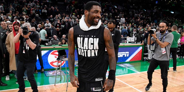 Kyrie Irving #11 of the Brooklyn Nets smiles after the game against the Boston Celtics on February 1, 2023 at the TD Garden in Boston, Massachusetts. 