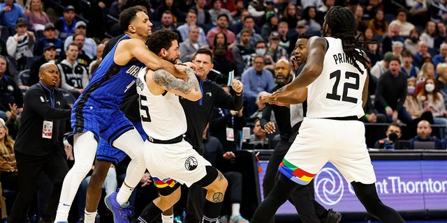 Jalen Suggs, #4 of the Orlando Magic, and Austin Rivers, #25 of the Minnesota Timberwolves, get into a scrum as Taurean Prince, #12, reacts in the third quarter of the game at Target Center on February 3, 2023, in Minneapolis, Minnesota. Suggs and Rivers were ejected from the game. 