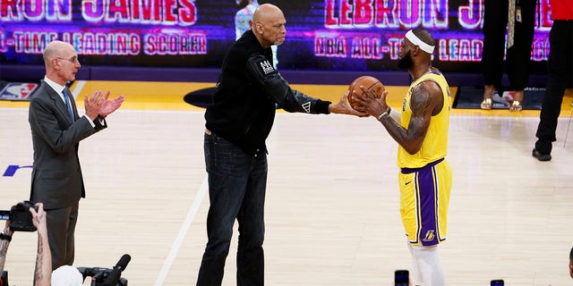 Kareem Abdul-Jabbar, left, passes a ball to LeBron James after James became the NBA's all-time scoring leader, passing Abdul-Jabbar at 38,388 points during the third quarter against the Oklahoma City Thunder at Crypto.com Arena Tuesday, Feb. 7, 2023, in Los Angeles. 