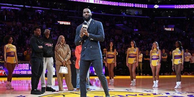 LeBron James of the Lakers talks to the crowd during a ceremony to honor him becoming the all-time leading scorer before the game against the Milwaukee Bucks on Feb. 9, 2023, at Crypto.Com Arena in Los Angeles.