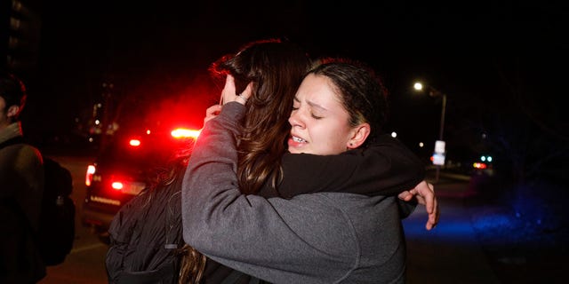 LANSING, MI - FEBRUARY 13: Michigan State University students hug during an active shooter situation on campus on February 13, 2023 in Lansing, Michigan. Five people were shot and the gunman still at large following the attack, according to published reports. The reports say some of the victims have life-threatening injuries.  (Photo by Bill Pugliano/Getty Images)