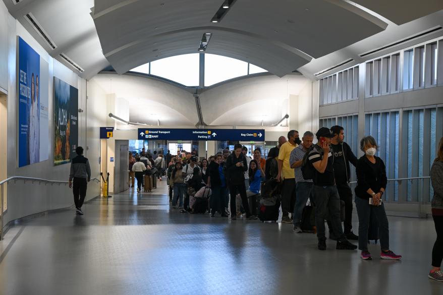 People are spotted in line at Oakland Airport during a major power outage in the Oakland area on Feb. 19, 2023.