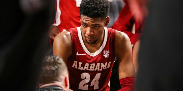 Brandon Miller listens to head coach Nate Oats of the Alabama Crimson Tide during a timeout during a game against the South Carolina Gamecocks Feb. 22, 2023, at Colonial Life Arena in Columbia, S.C.