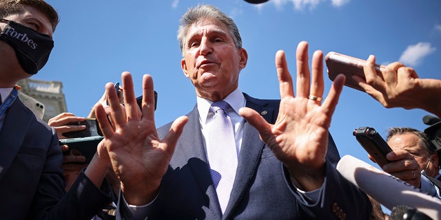 Sen. Joe Manchin speaks to reporters outside the Capitol on Sept. 30, 2021.