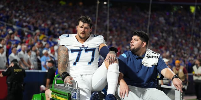 Taylor Lewan #77 of the Tennessee Titans gets carted off of the field after suffering an injury against the Buffalo Bills at Highmark Stadium on September 19, 2022 in Orchard Park, New York. 