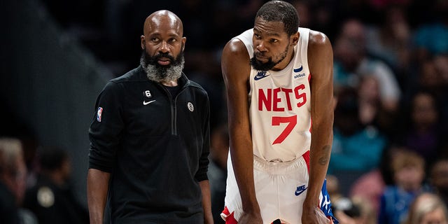 Interim head coach Jacque Vaughn of the Brooklyn Nets talks with Kevin Durant (7) during a game at Spectrum Center Nov. 5, 2022, in Charlotte, N.C. 