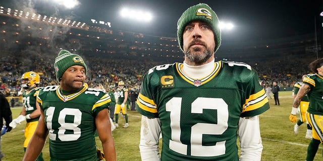 Aaron Rodgers #12 and Randall Cobb #18 of the Green Bay Packers walk off the field after losing to the Detroit Lions at Lambeau Field on January 08, 2023 in Green Bay, Wisconsin. 