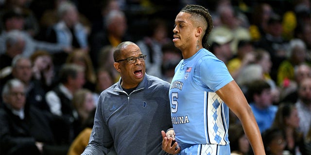 North Carolina Tar Heels head coach Hubert Davis talks with Armando Bacot, #5, during the first half of their game against the Wake Forest Demon Deacons at Lawrence Joel Veterans Memorial Coliseum on Feb. 7, 2023 in Winston-Salem, North Carolina.  