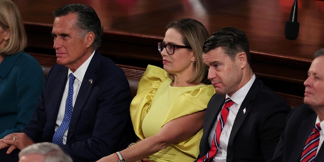 Sen. Mitt Romney, R-UT, Sen. Kyrsten Sinema, I-AZ, and Sen. Todd Young, R-IN, sit together during President Biden's State of the Union address on February 07, 2023, in Washington, DC. 