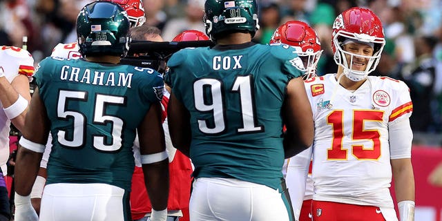 Patrick Mahomes of the Kansas City Chiefs reacts with Brandon Graham and Fletcher Cox of the Philadelphia Eagles during the coin toss before Super Bowl LVII on Feb. 12, 2023, in Glendale, Arizona.