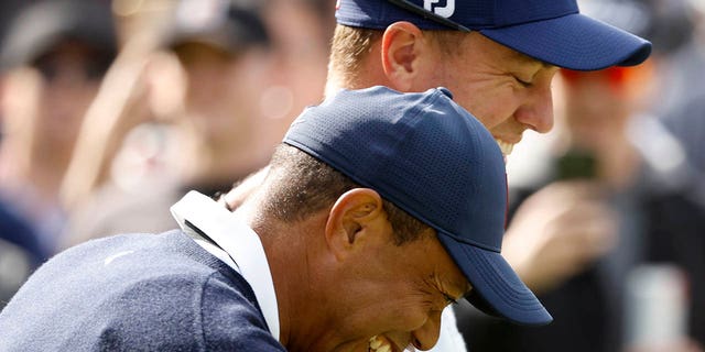 Tiger Woods of the United States and Justin Thomas of the United States walk across the ninth hole during the first round of the The Genesis Invitational at Riviera Country Club on February 16, 2023 in Pacific Palisades, California. 