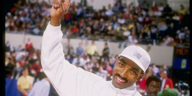 Greg Foster celebrates after setting a new world record during the Sunkist Track Meet at the Los Angeles Memorial Coliseum.