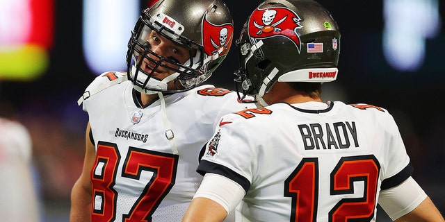 Tom Brady and Rob Gronkowski of the Tampa Bay Buccaneers talk before the Falcons game at Mercedes-Benz Stadium on Dec. 5, 2021, in Atlanta.