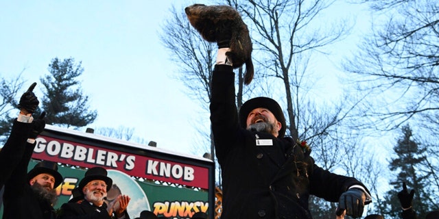 Groundhog Club handler A.J. Dereume holds Punxsutawney Phil, the weather prognosticating groundhog, during the 136th celebration of Groundhog Day on Gobbler's Knob in Punxsutawney, Pa., Feb. 2, 2022. 